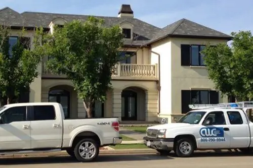 A Caprock Window Cleaning truck with the phone number 806-790-9944 on the door, parked at a large stucco home