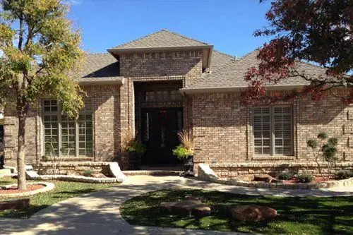 A brick home in Lubbock with plantation-shuttered windows
