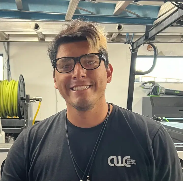 Justin, a crew lead at Caprock Window Cleaning, in a CWC shirt